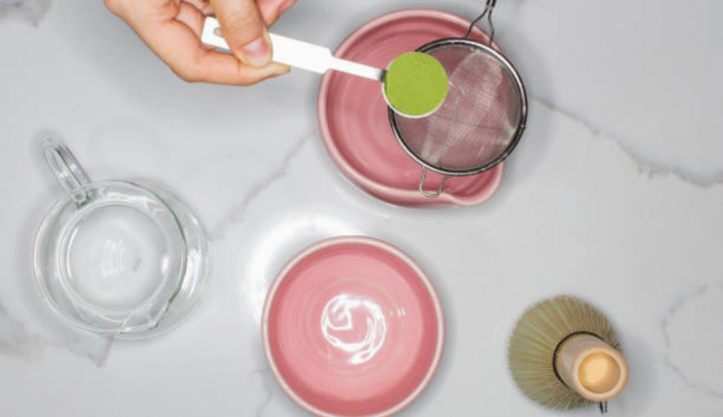 whisk the matcha powder with hot water